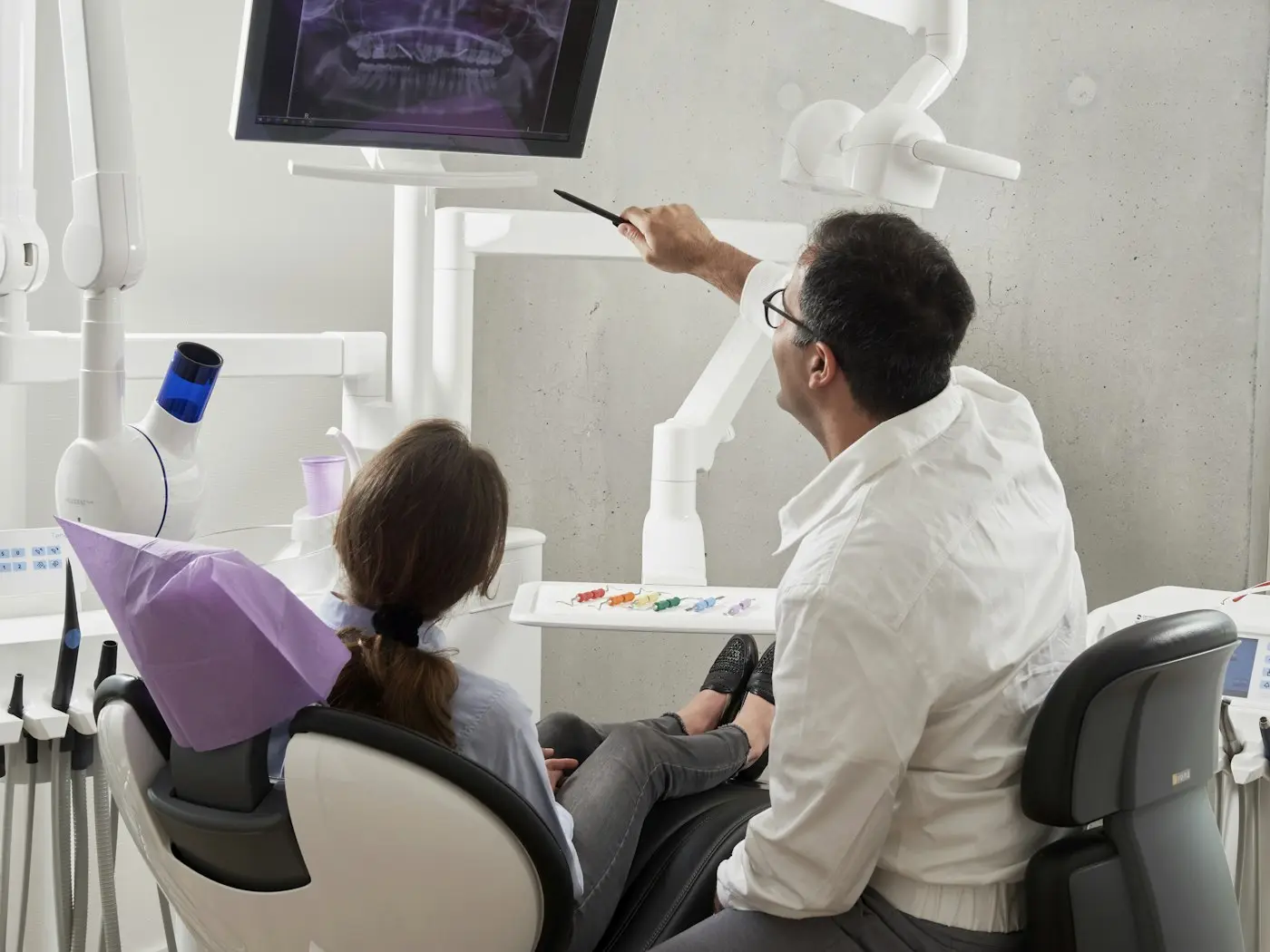Dentist explaining a treatment to a patient
